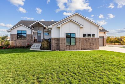 View of front facade with a front lawn | Image 1