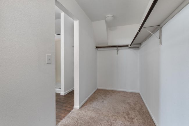 Walk in closet featuring carpet | Image 19