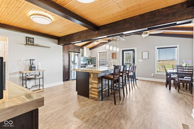 Extra large Kitchen, with breakfast bar, stainless steel refrigerator with ice dispenser, laminate floors | Image 11