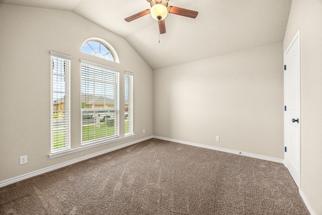 Empty room with vaulted ceiling, carpet flooring, and ceiling fan | Image 19