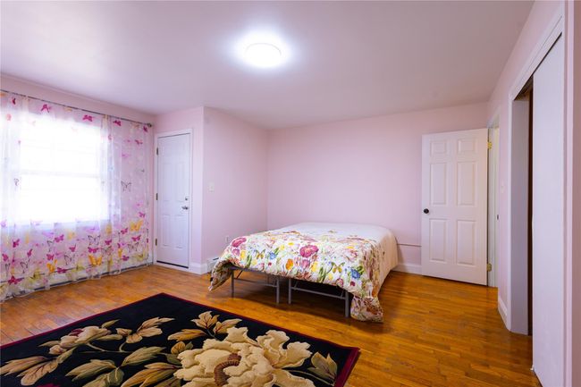 Primary bedroom with baseboards and hardwood / wood-style floors | Image 12
