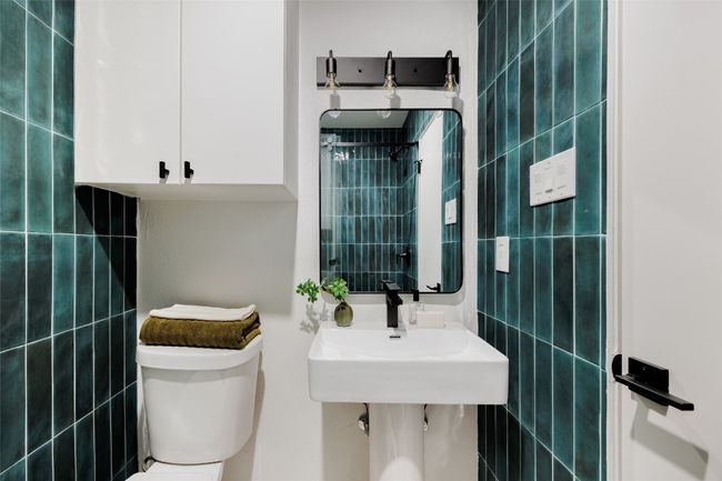 Full bath featuring tile walls and a shower | Image 23