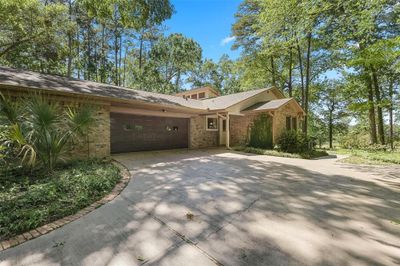 Oversized 2-car garage complete with workshop area and driveway to accommodate company. | Image 3