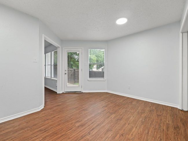Unfurnished room featuring wood finished floors and a textured ceiling | Image 4