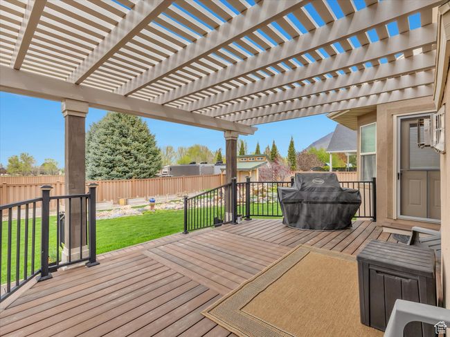 Wooden deck featuring a fenced backyard, a pergola, and a yard | Image 42