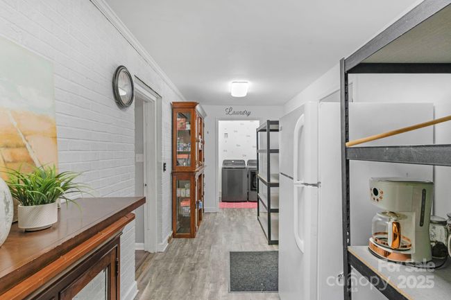 Back entry near the kitchen leads to convenient mud/storage space and laundry room! | Image 36