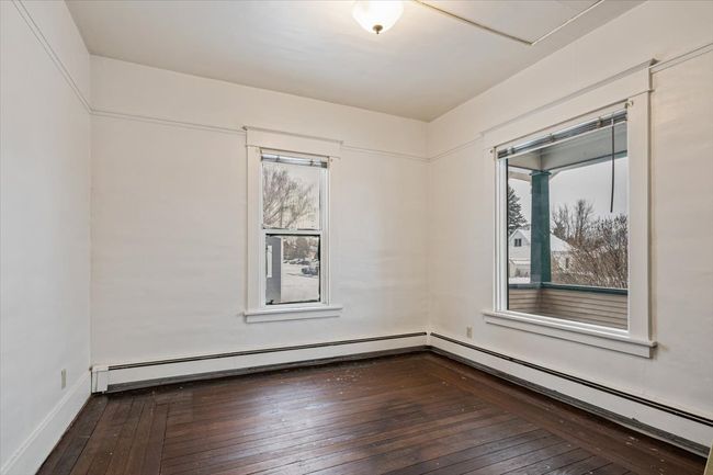 Empty room with hardwood / wood-style flooring and a baseboard heating unit | Image 9