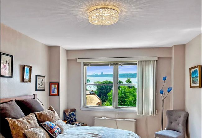 Bedroom with a chandelier and a water view | Image 6