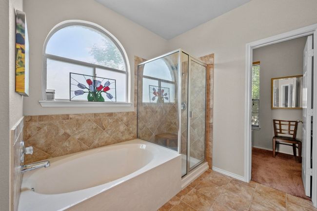 Kick back and relax after a long day in the deep soaking tub or in the refreshing walk-in shower. | Image 14