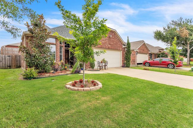 View of front of home with brick siding, a garage, concrete driveway, and roof with shingles | Image 26