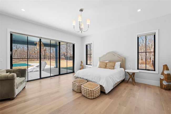 Bedroom with access to outside, a chandelier, light wood-style flooring, multiple windows, and recessed lighting | Image 30