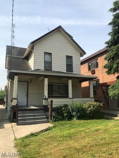 Back of property featuring a lawn and a porch | Image 1