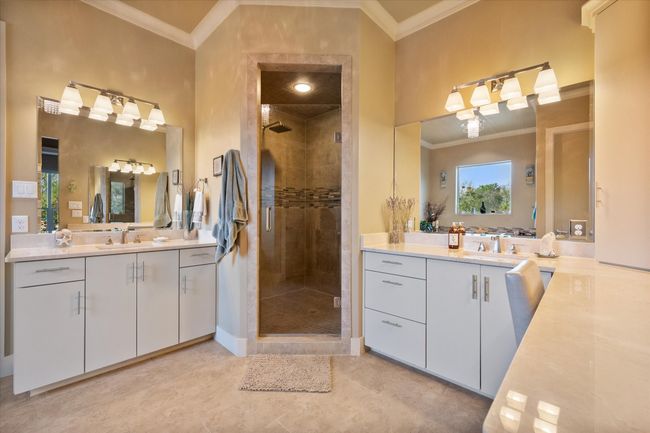 Primary bath featuring double vanities, jetted tub and oversized multi head shower | Image 16