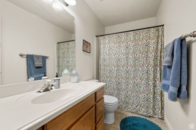 Full bathroom featuring vanity, a shower with curtain, and tile patterned flooring | Image 14