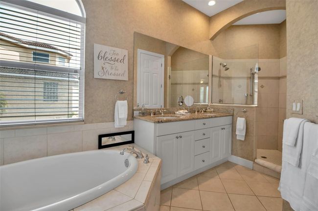 Primary bath with soaking tub and dual head walk-in shower | Image 37