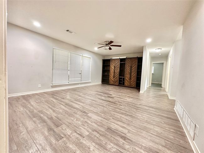 Unfurnished living room with ceiling fan, light wood finished floors, and recessed lighting | Image 8