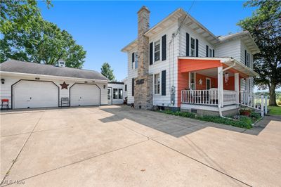 View of front facade featuring a garage and covered porch | Image 1