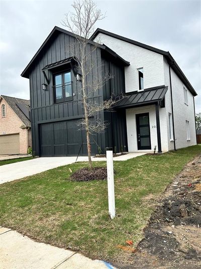 Modern inspired farmhouse with a front lawn and a garage | Image 2