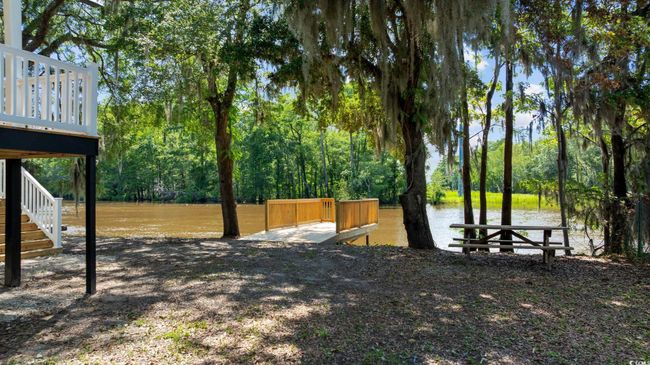 View of yard with a water view, stairs, and a wooded view | Image 31