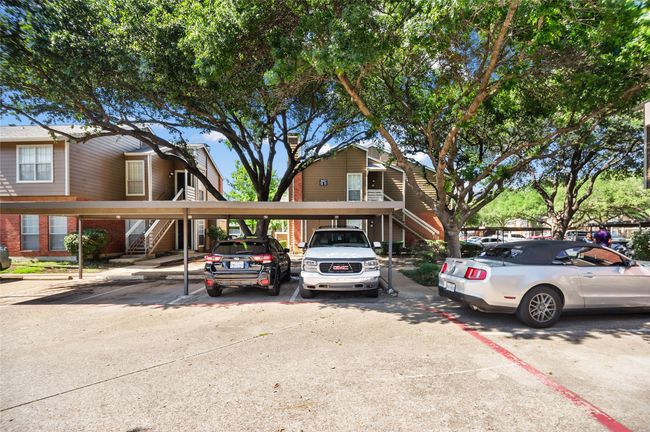 View of front of property featuring stairway, covered parking, and brick siding | Image 20