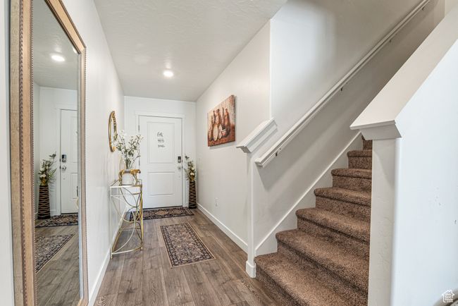 Foyer featuring wood finished floors, baseboards, stairs, and recessed lighting | Image 5