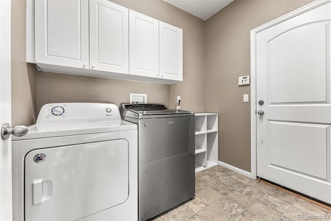 Main floor laundry adjacent to the garage | Image 16