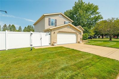 View of home's exterior with a garage and a yard | Image 3