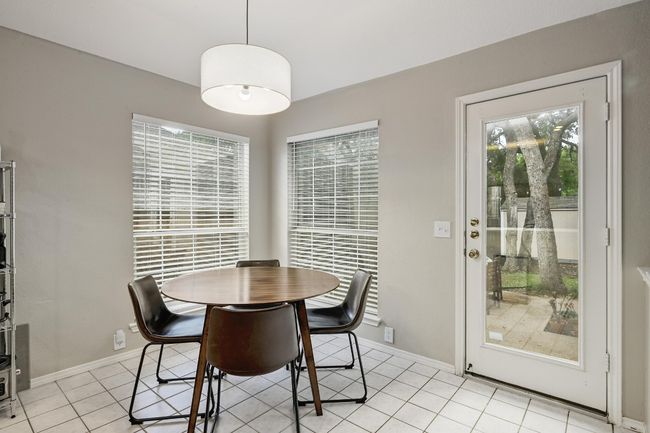 Breakfast area featuring light tile patterned floors and access to back yard | Image 21