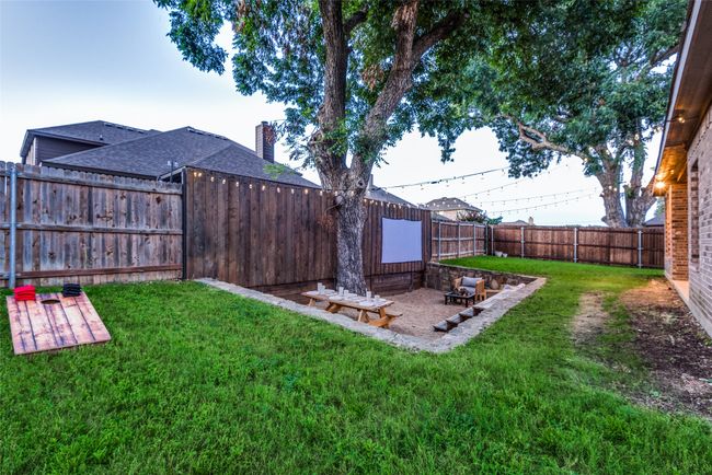 View of yard featuring a fenced backyard and a patio | Image 4