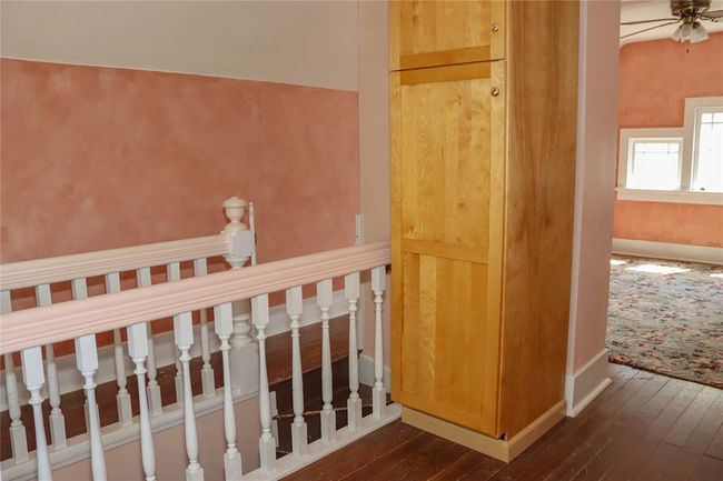 Your third floor bonus room, with a cabinet in the center for storage. | Image 39
