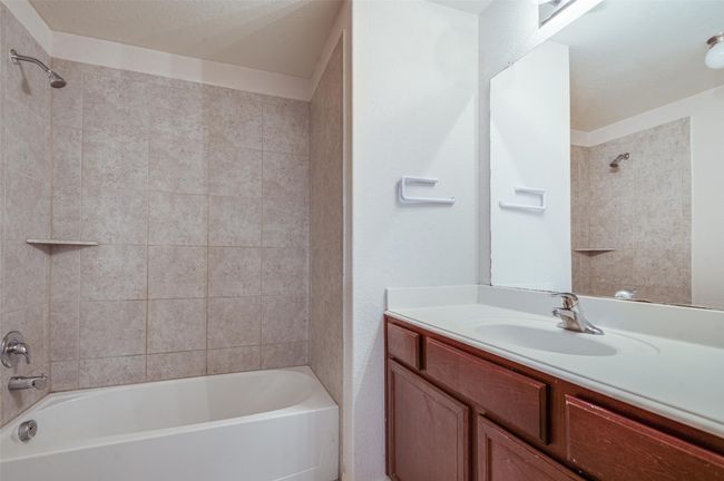 Bathroom featuring shower / bath combination and vanity | Image 22