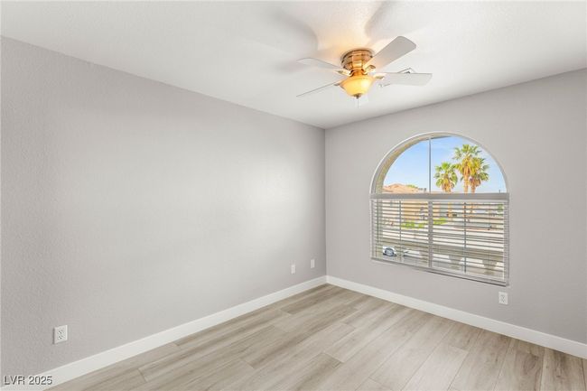 Spare room with ceiling fan, baseboards, and light wood-type flooring | Image 20