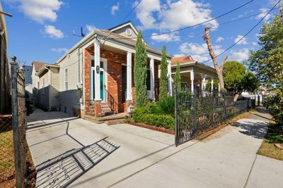 Off-street parking fits two cars with lush front gardens and a wrought iron fence | Image 1