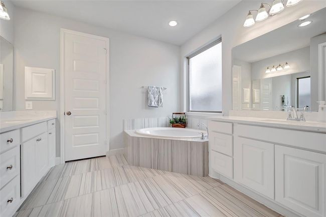 Primary bathroom with separate vanities, 2 walk-in closets, separate shower and private water closet. | Image 18
