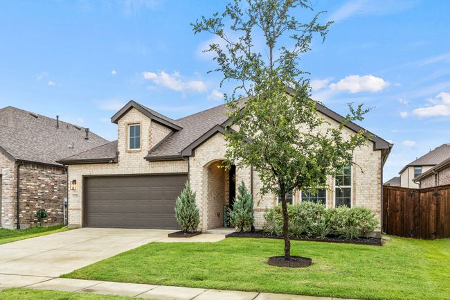 French provincial home with brick siding, roof with shingles, an attached garage, and driveway | Image 21