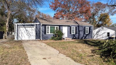 View of front of property featuring a front lawn and a garage | Image 1