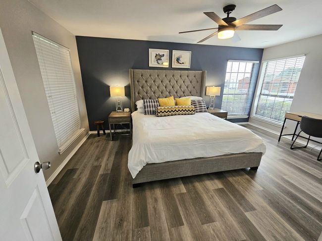 Bedroom featuring wood finished floors, baseboards, and ceiling fan | Image 8