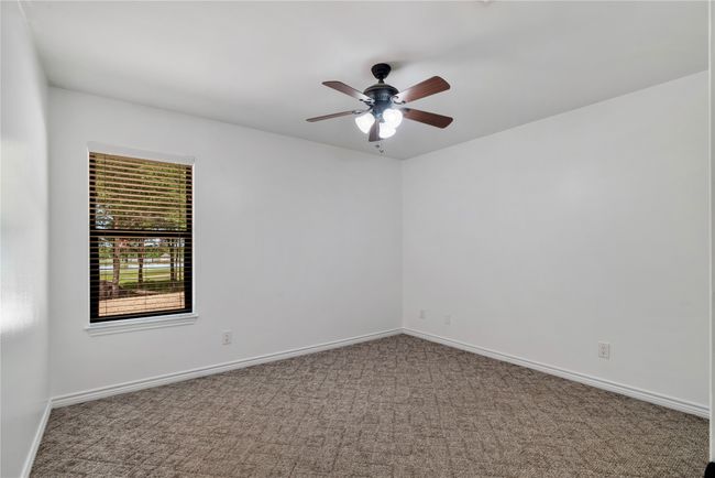 Carpeted spare room with baseboards and a ceiling fan | Image 17