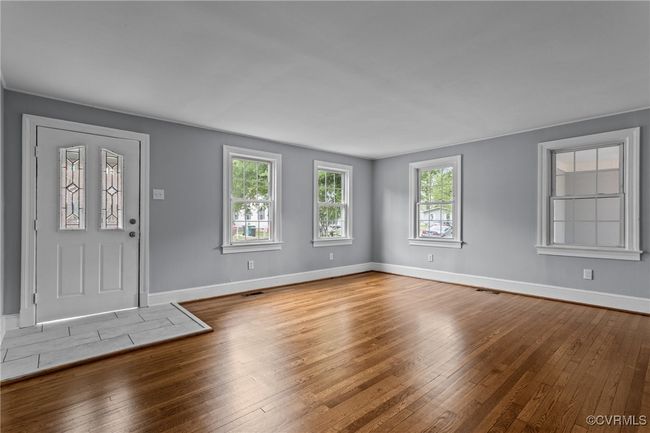 Foyer entrance featuring visible vents, hardwood / wood-style flooring, and baseboards | Image 5