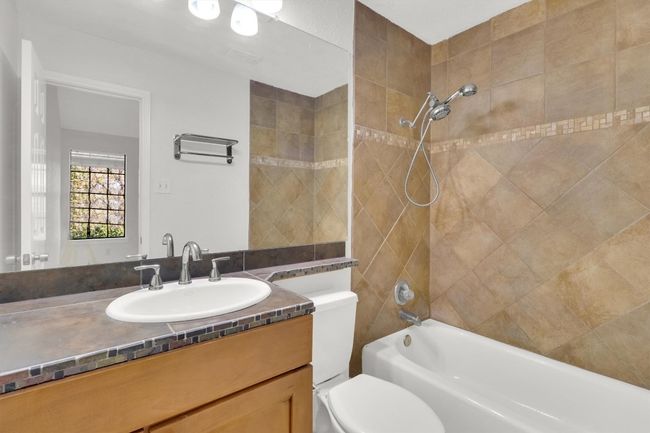 Full bath with toilet, vanity, and shower / washtub combination | Image 19