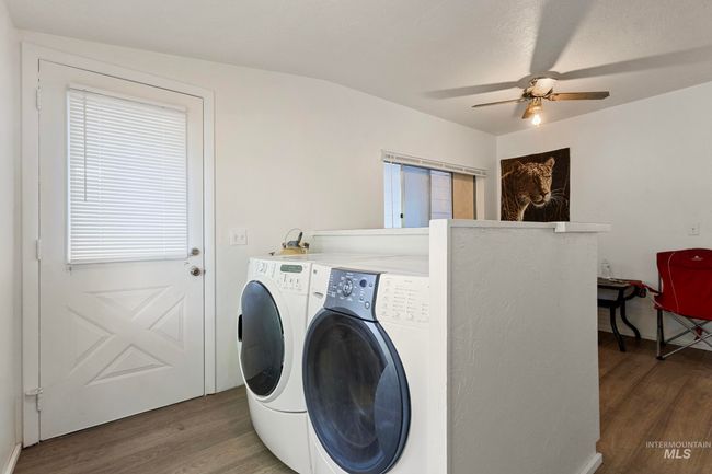 Laundry room with separate washer and dryer, wood finished floors, and ceiling fan | Image 7