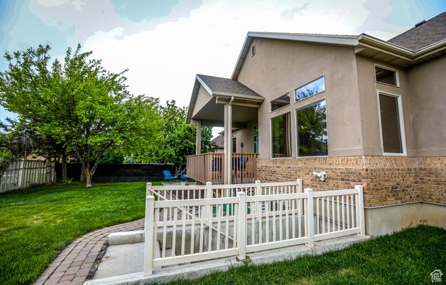 Back of property featuring stucco siding, brick siding, and a shingled roof | Image 40