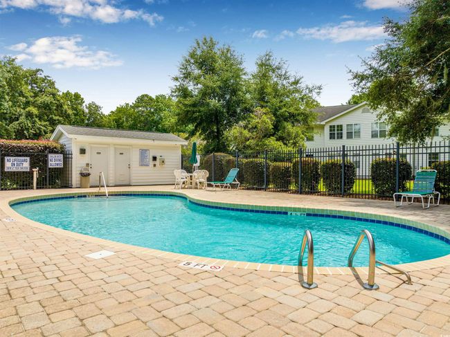 Community pool with a patio area | Image 35