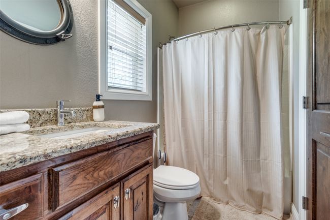 Bathroom featuring vanity with cabinet space and toilet | Image 10