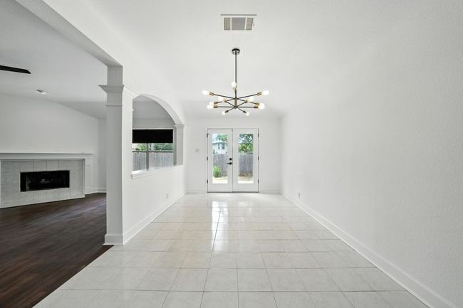 The spacious living room features a cozy gas fireplace and flows seamlessly into a large dining area—perfect for entertaining. | Image 11
