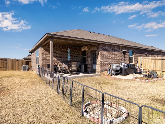 Rear view of property with a yard, central AC, and a patio area | Image 28