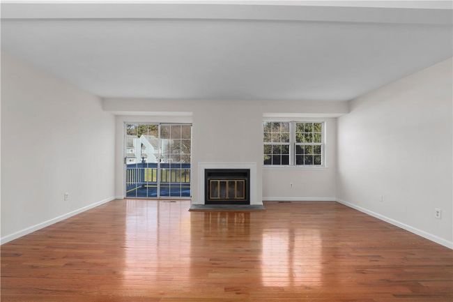 Living room with fireplace and sliding glass doors to deck. | Image 5