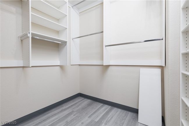 Spacious closet with light wood finished floors | Image 24
