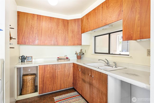 The small but functional kitchen could be refreshed or gut this space and rework the whole space. | Image 14