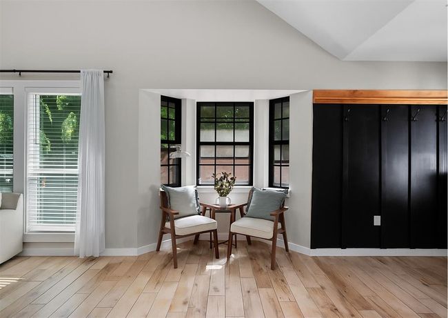 Cozy conversation corner with black-trimmed bay windows, perfect for morning coffee or evening chats. | Image 22